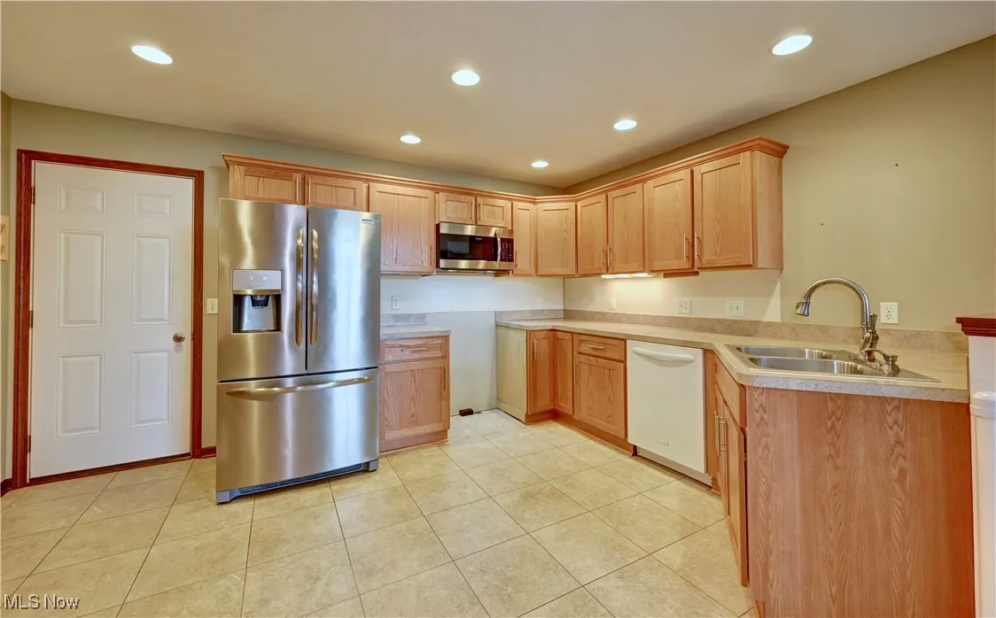 Kitchen featuring stainless steel appliances, recessed lighting, light countertops, and light tile patterned floors