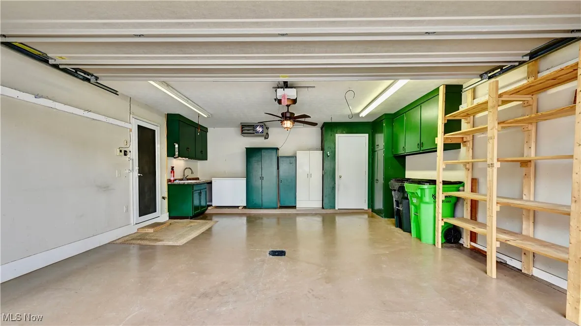 Garage with a sink and a garage door opener