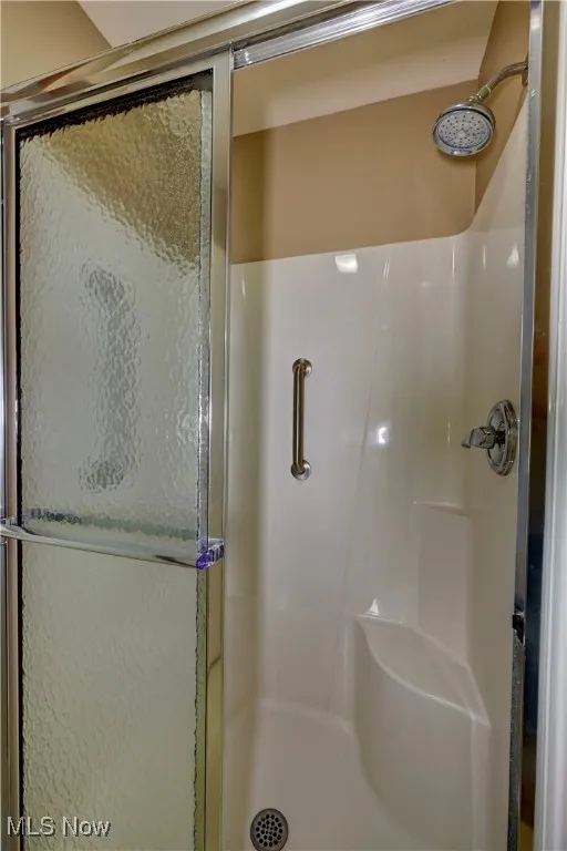 Full bathroom featuring a stall shower
