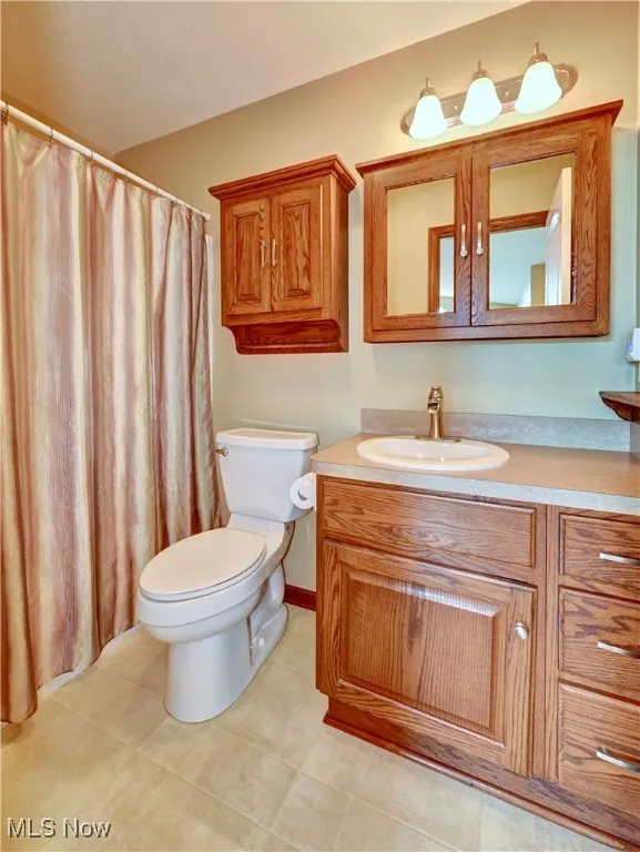Full bathroom featuring vanity and tile patterned flooring