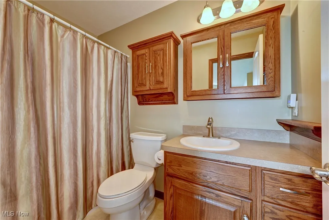 Full bath featuring vanity and toilet