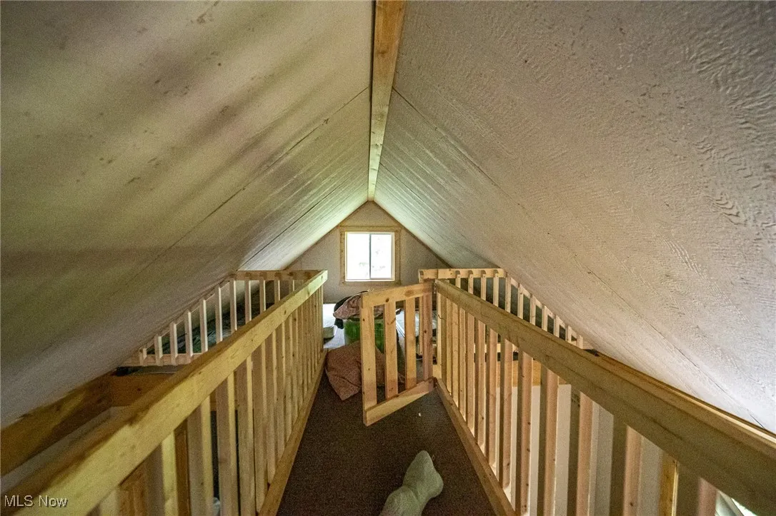 Additional living space featuring vaulted ceiling