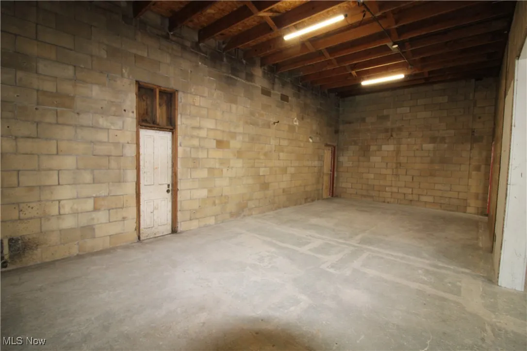 Basement featuring concrete block wall