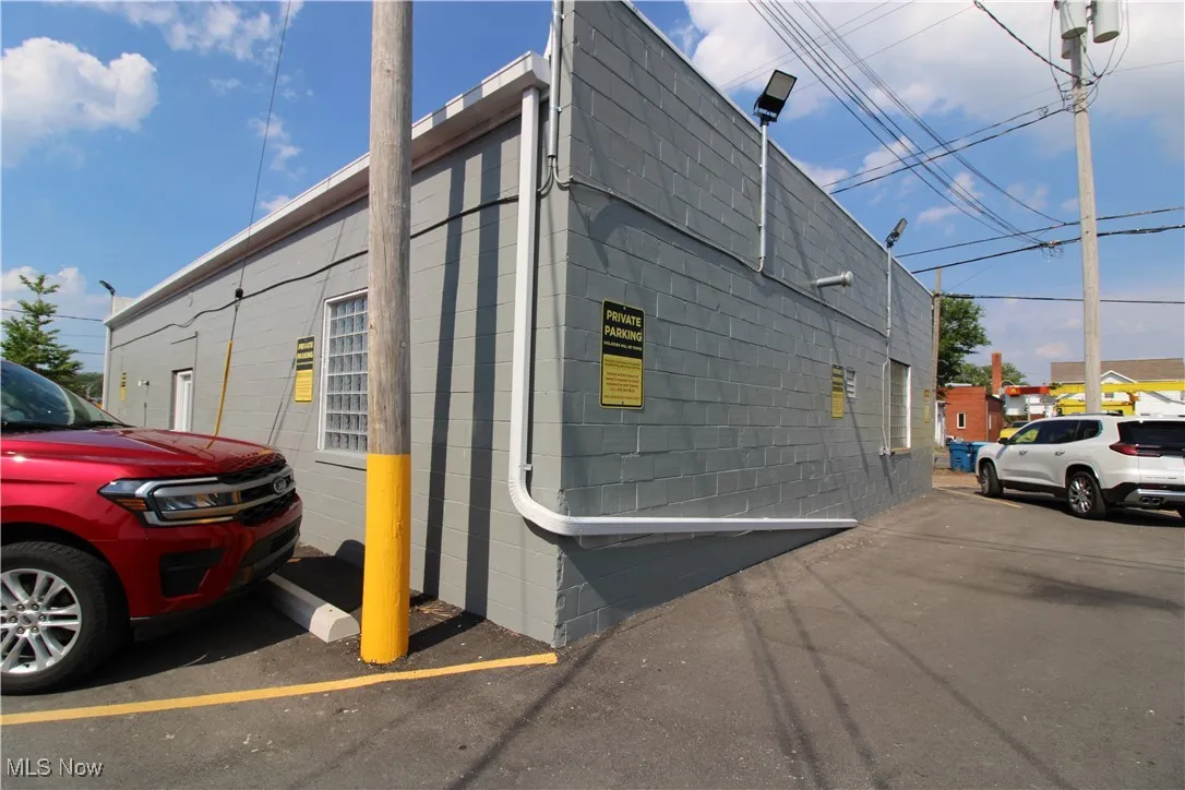 View of building exterior featuring uncovered parking