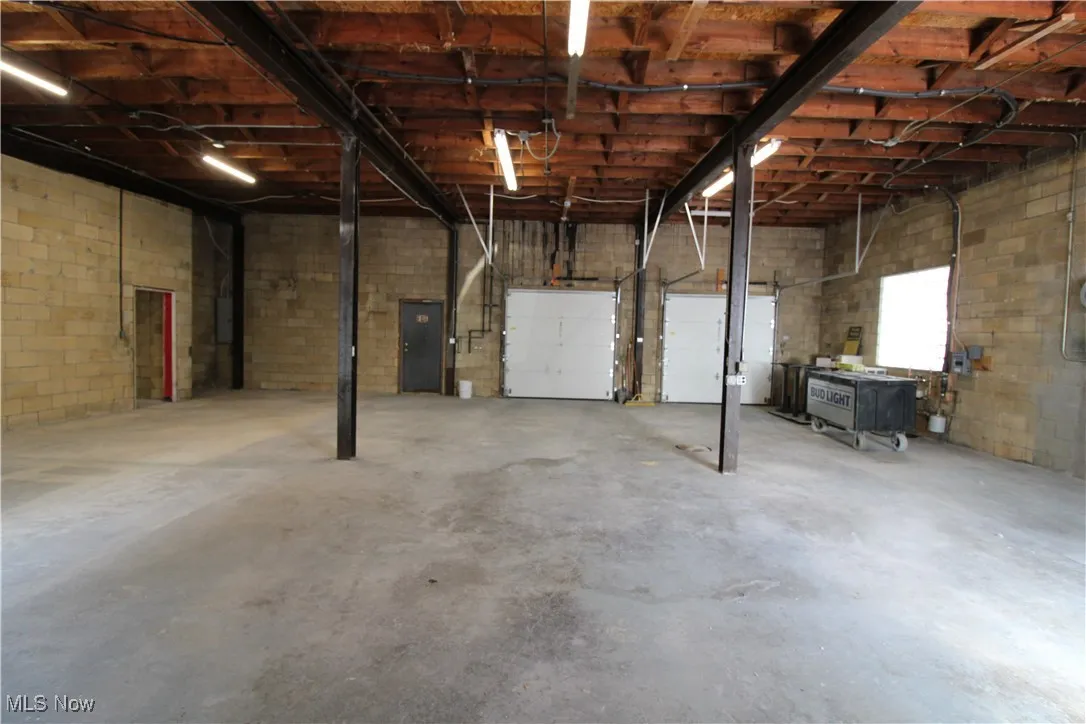Basement with concrete block wall and a garage