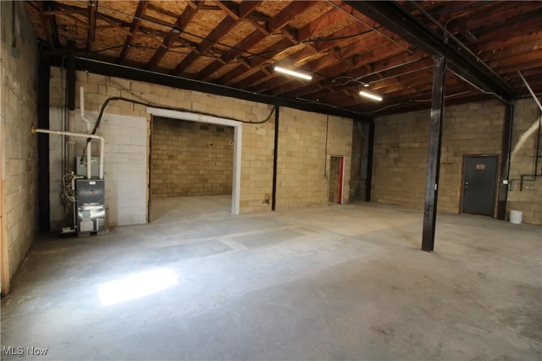 Unfinished basement with concrete block wall