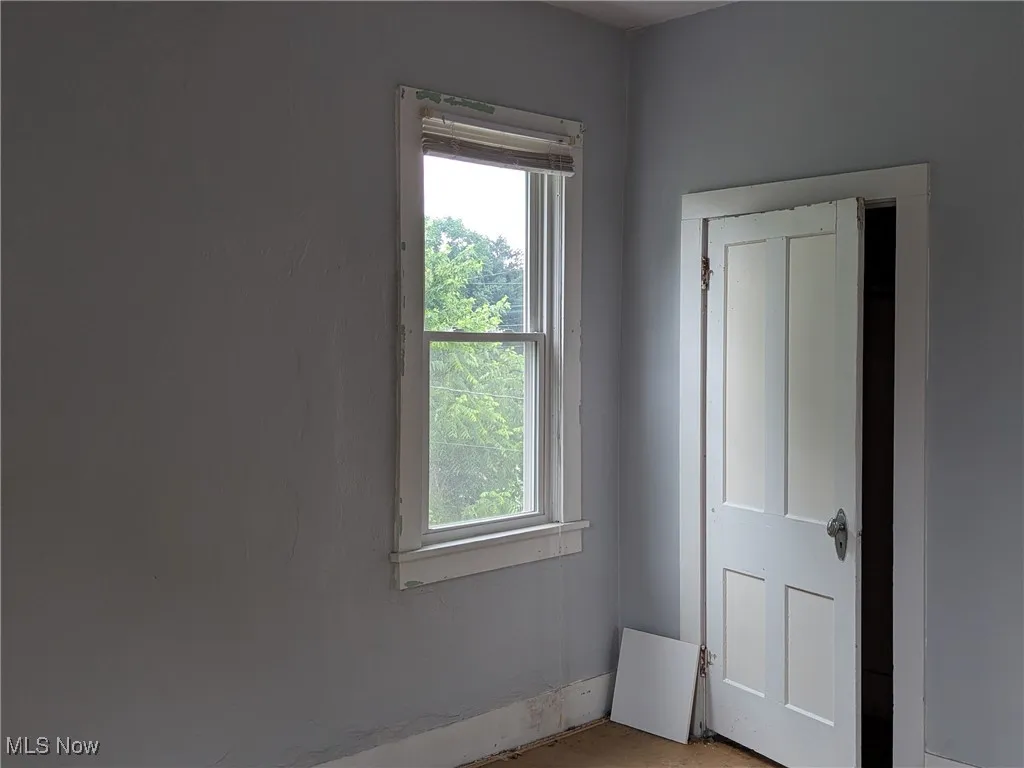 Unfurnished bedroom with multiple windows