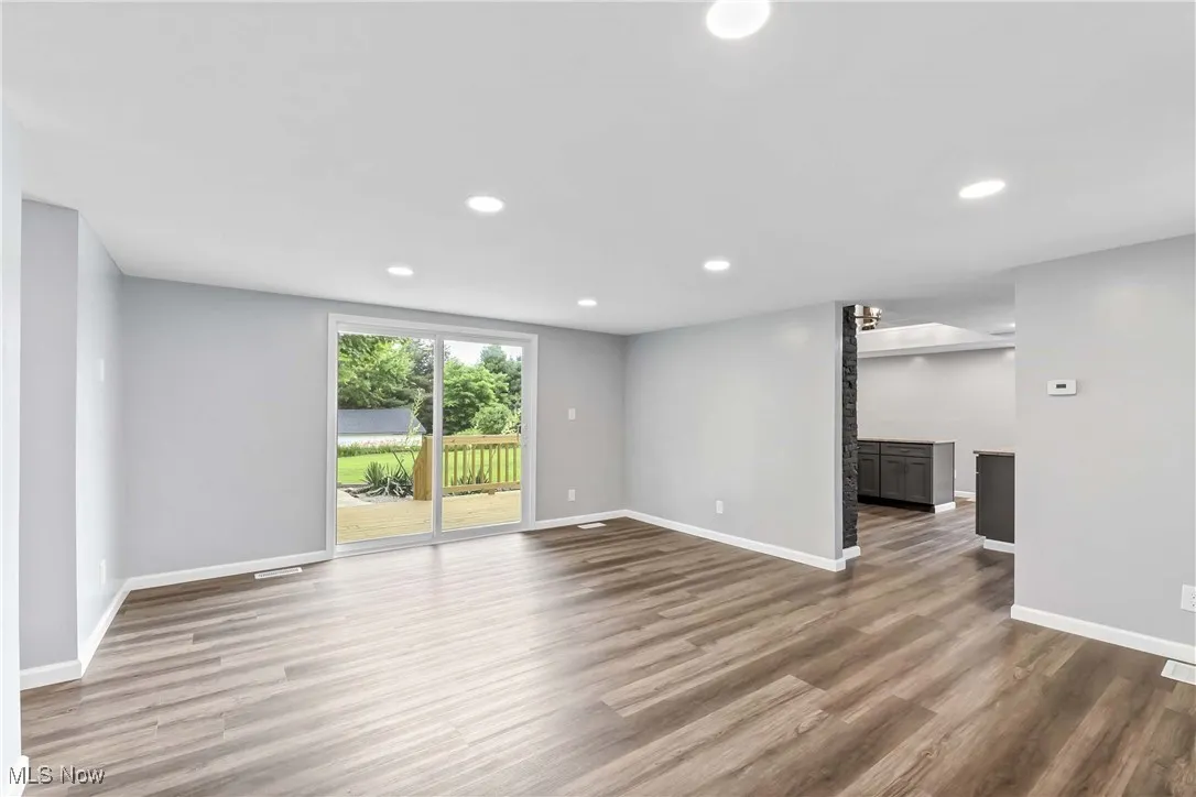 Unfurnished room with wood finished floors and recessed lighting