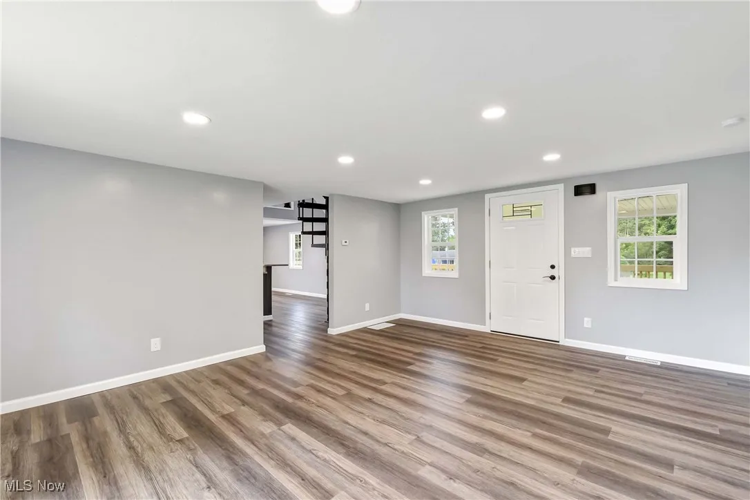 Foyer entrance featuring wood finished floors, recessed lighting, and healthy amount of natural light