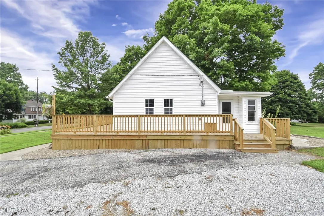 View of front facade with a wooden deck