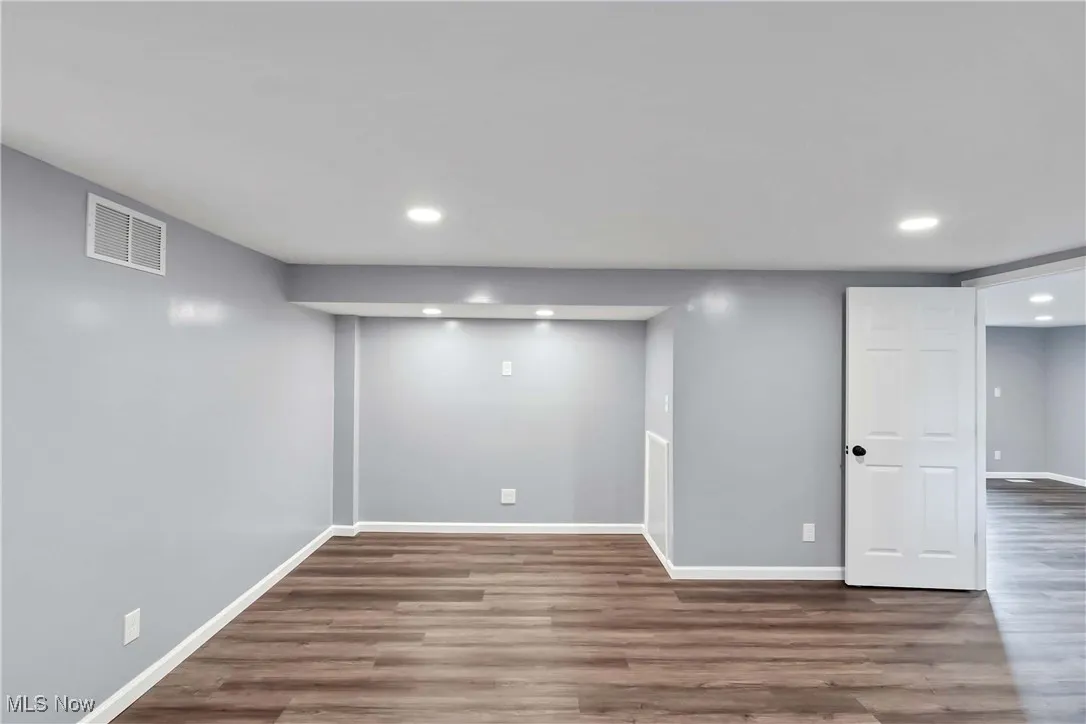 Finished basement with recessed lighting and wood finished floors