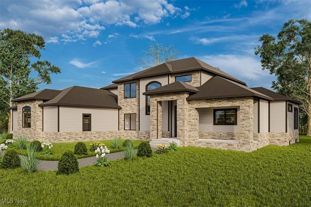 View of front of property with a front lawn, brick siding, and stone siding