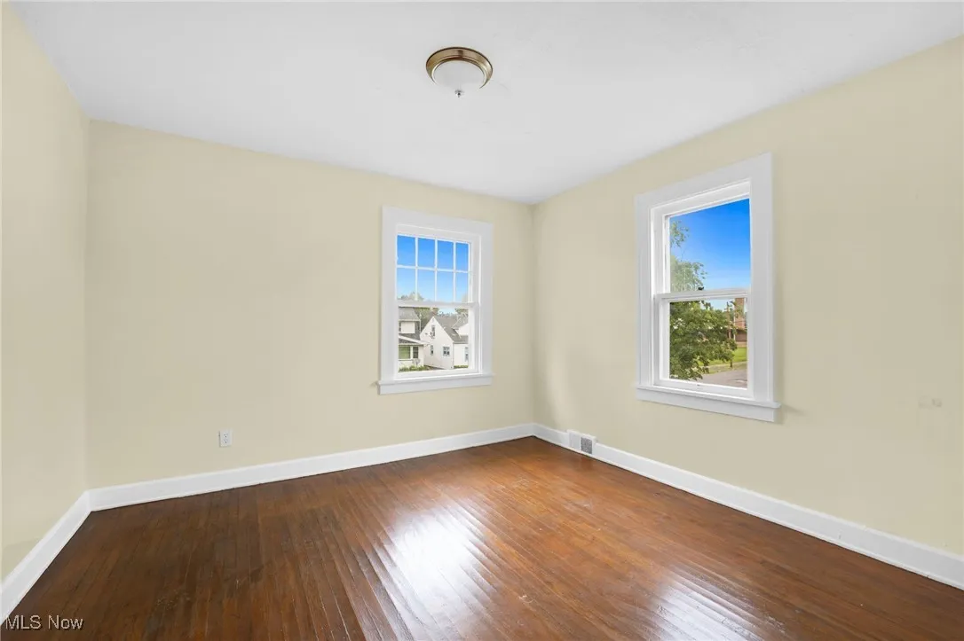 Unfurnished room with plenty of natural light and hardwood / wood-style flooring