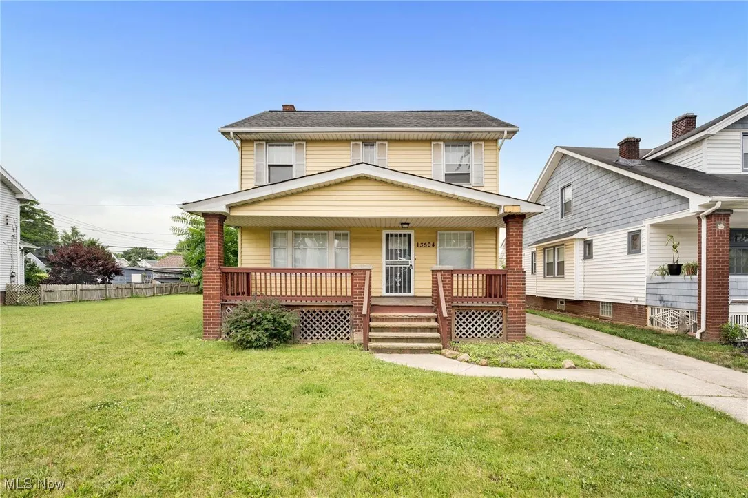 American foursquare style home featuring covered porch