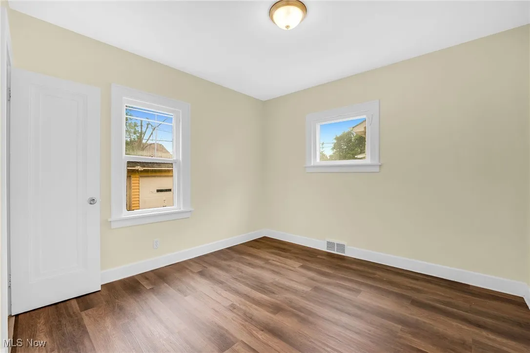 Unfurnished bedroom with wood finished floors