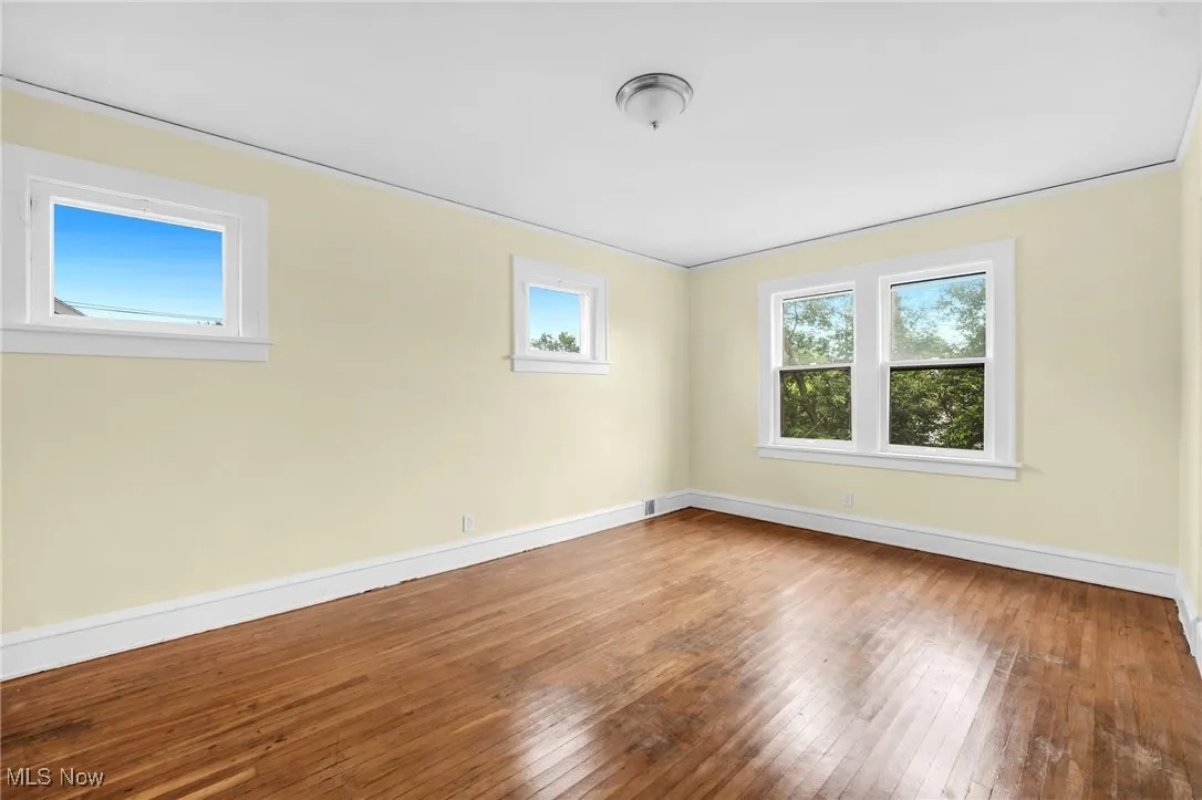 Unfurnished room with hardwood / wood-style flooring