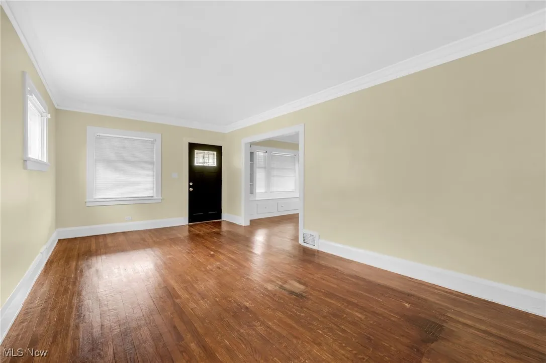 Entryway with crown molding, hardwood / wood-style floors, and plenty of natural light