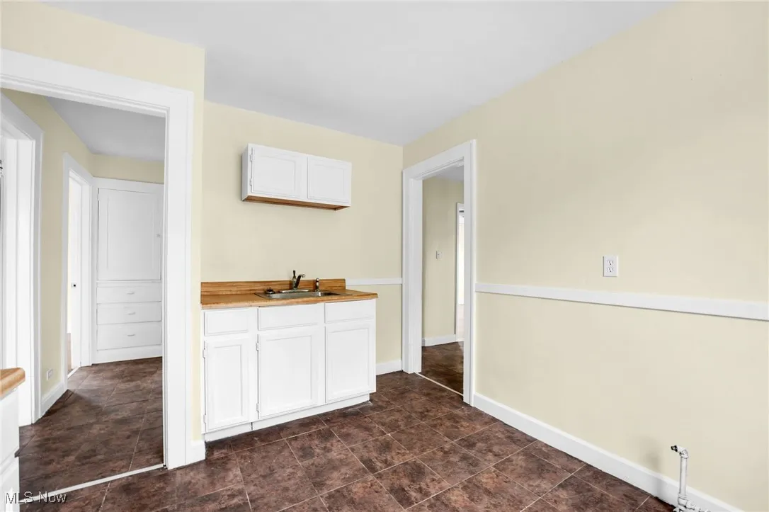 Kitchen featuring white cabinetry and light countertops