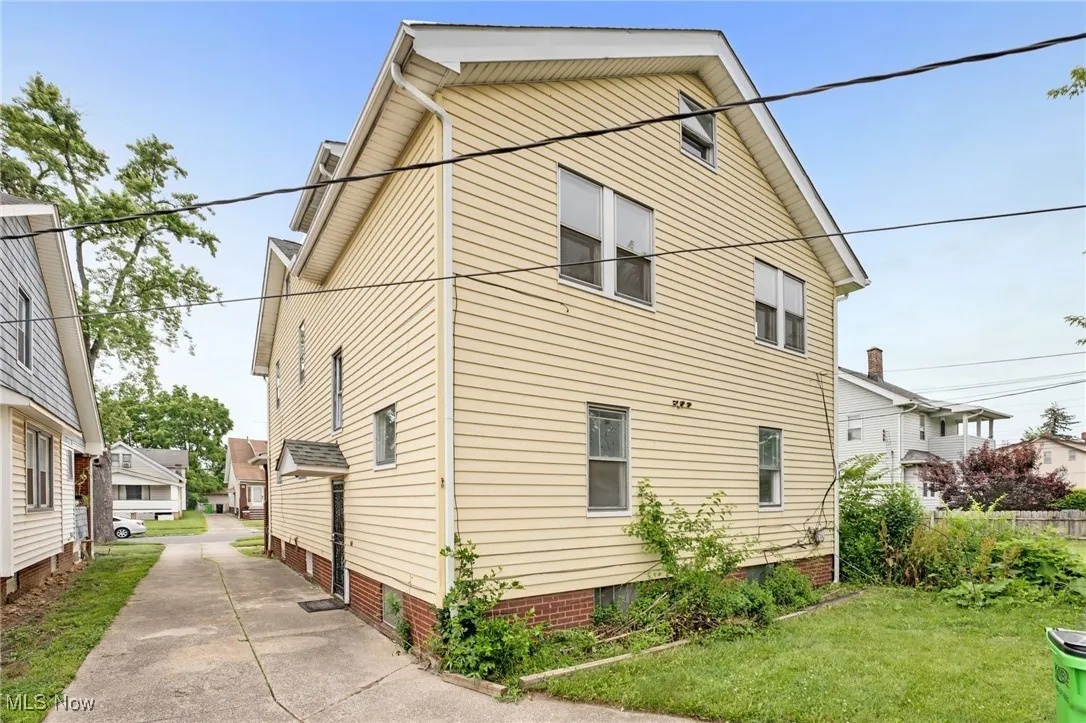 View of property exterior featuring a lawn