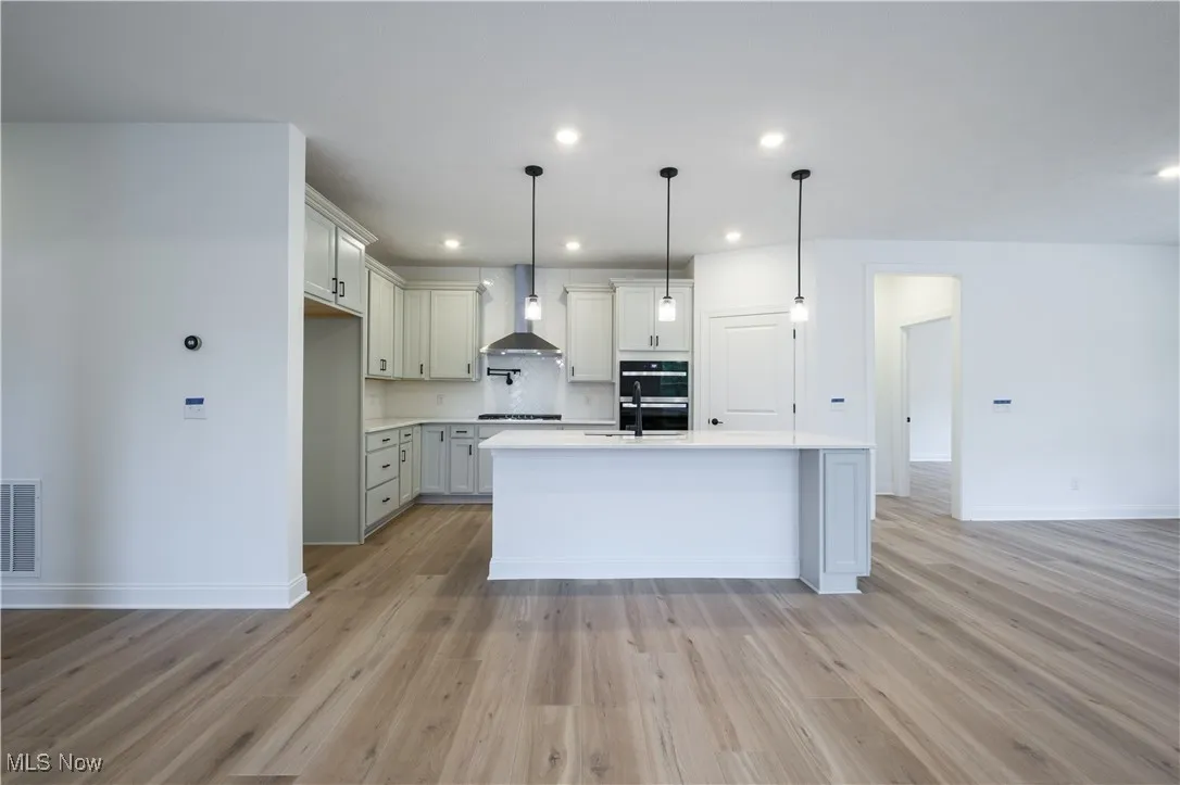Open layout kitchen with upgraded maple cabinetry