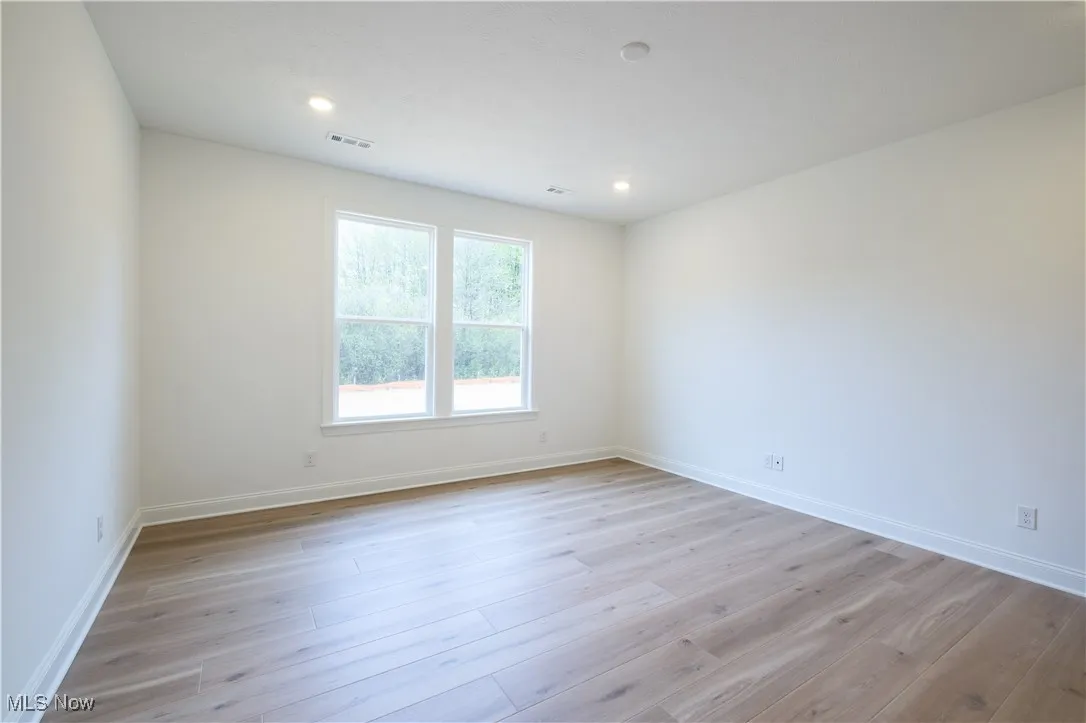 Large owner's bedroom with abundant natural light.
