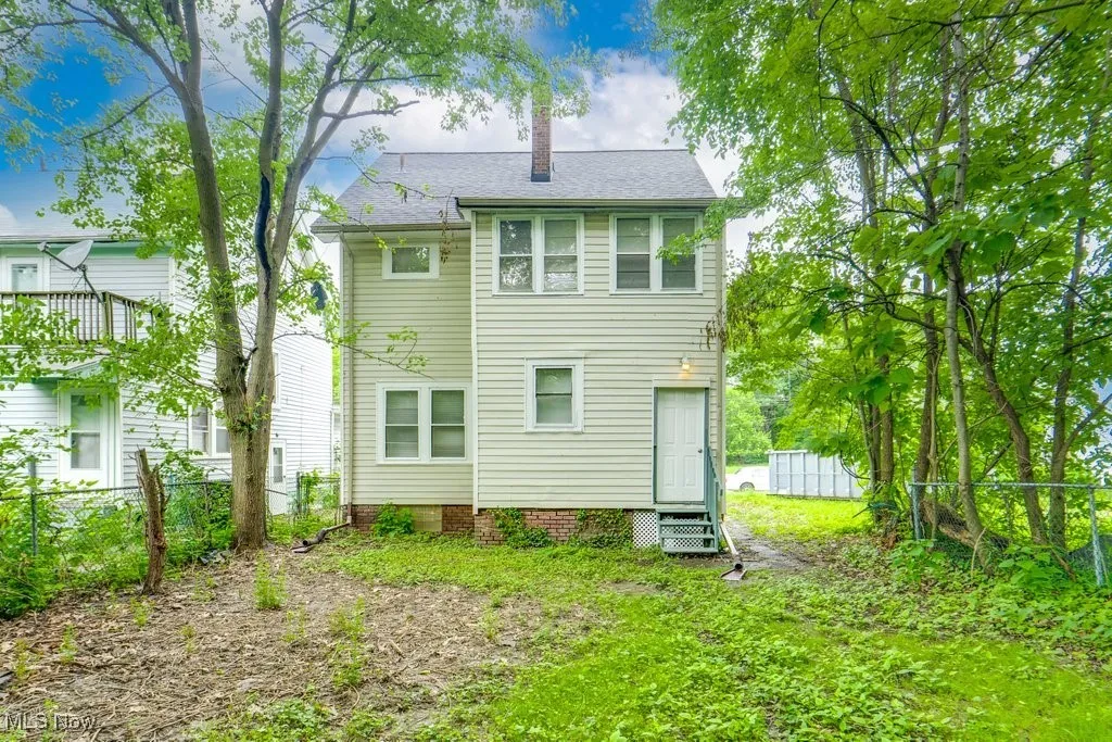 Back of property with a chimney and entry steps