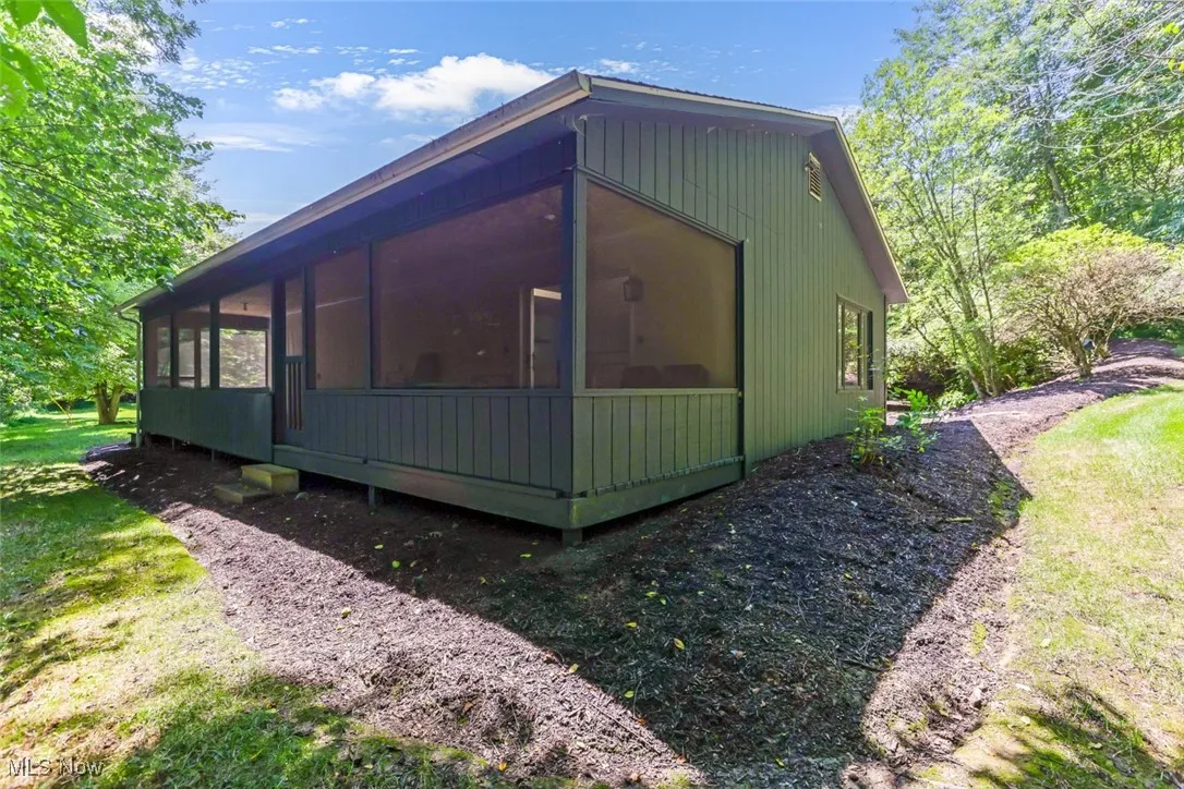 View of home's exterior with a sunroom