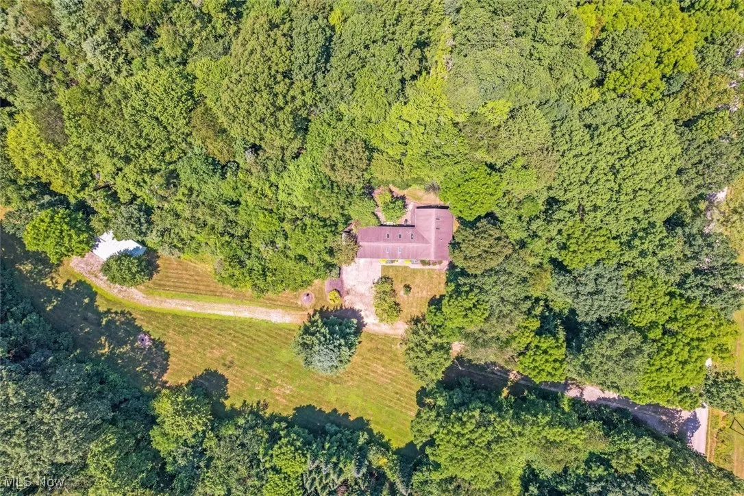 View of property location featuring a heavily wooded area