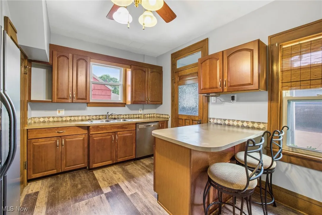 Kitchen featuring appliances with stainless steel finishes, a kitchen bar