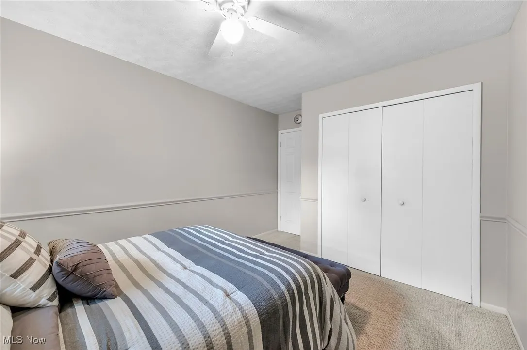 Bedroom featuring carpet floors, a closet, and ceiling fan