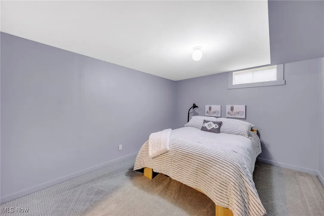 Carpeted bedroom featuring baseboards