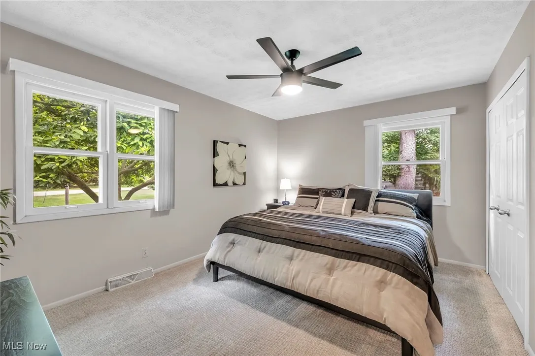 Bedroom with carpet floors and baseboards
