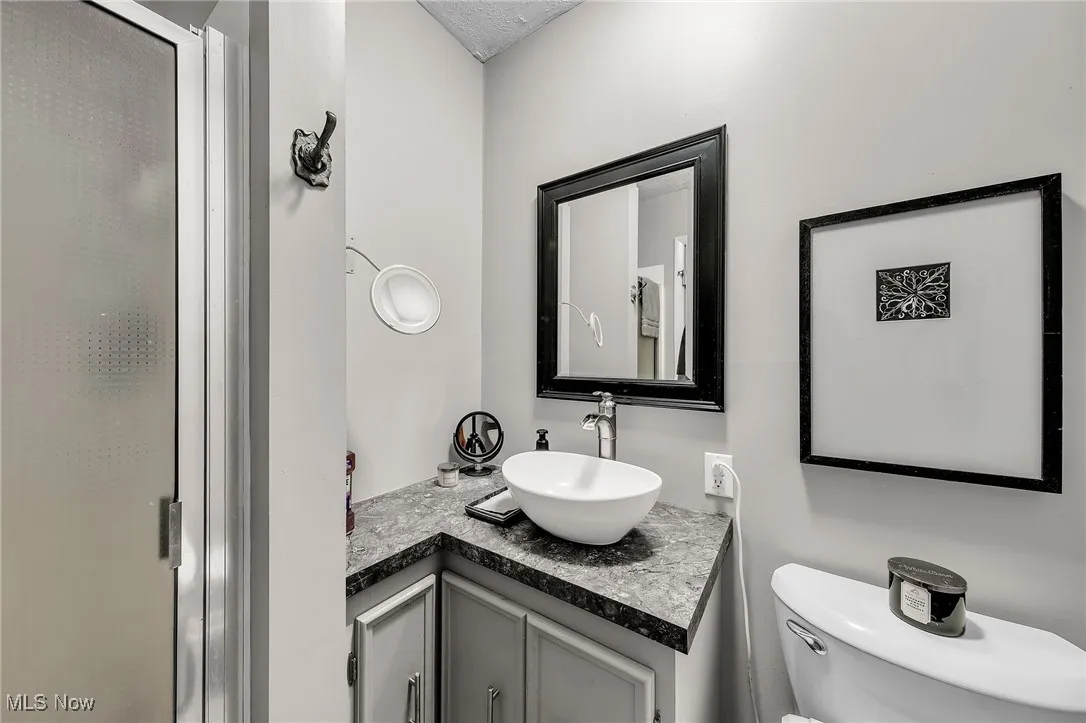 Bathroom featuring vanity and a stall shower