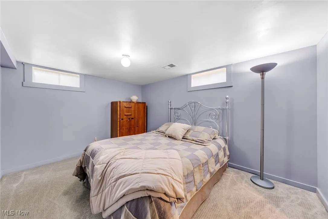 Bedroom with carpet floors and baseboards