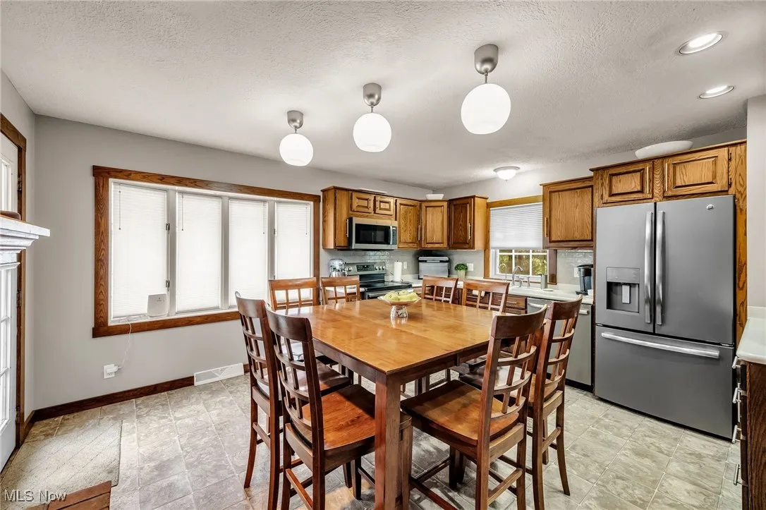 Dining room with a textured ceiling and recessed lighting