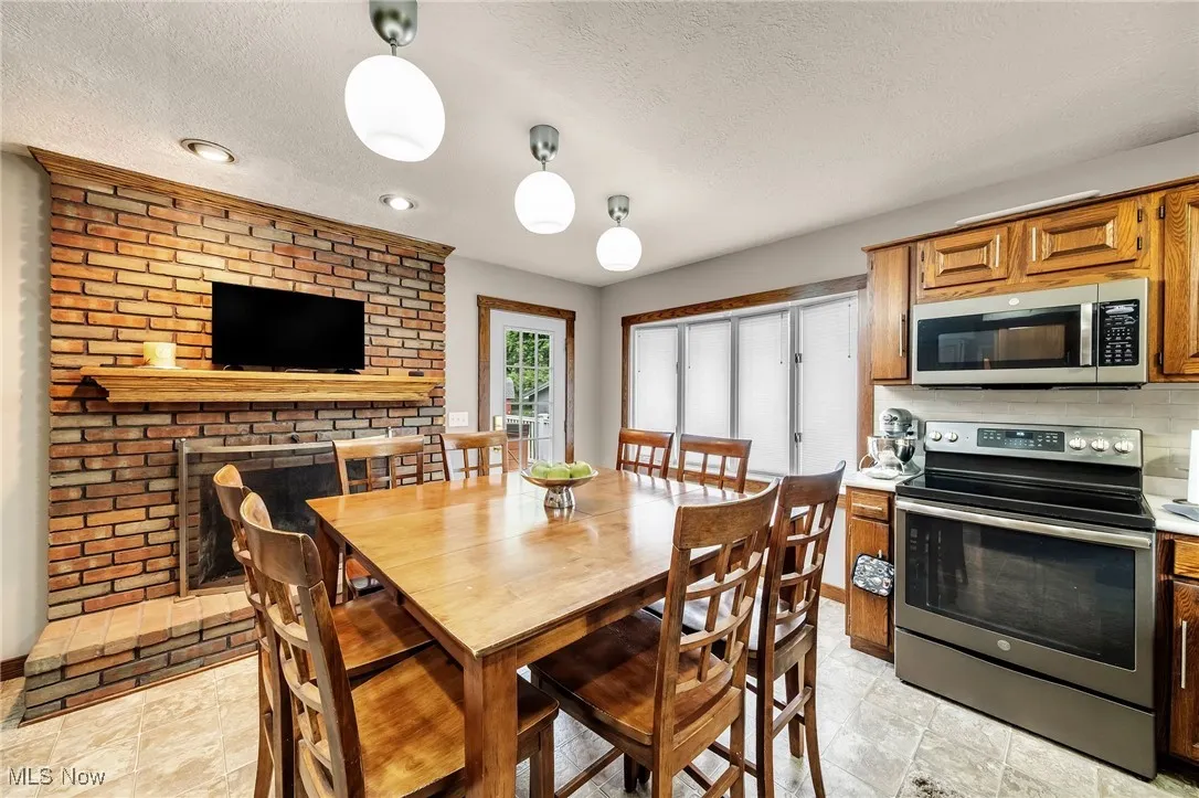 Dining room featuring a textured ceiling and recessed lighting