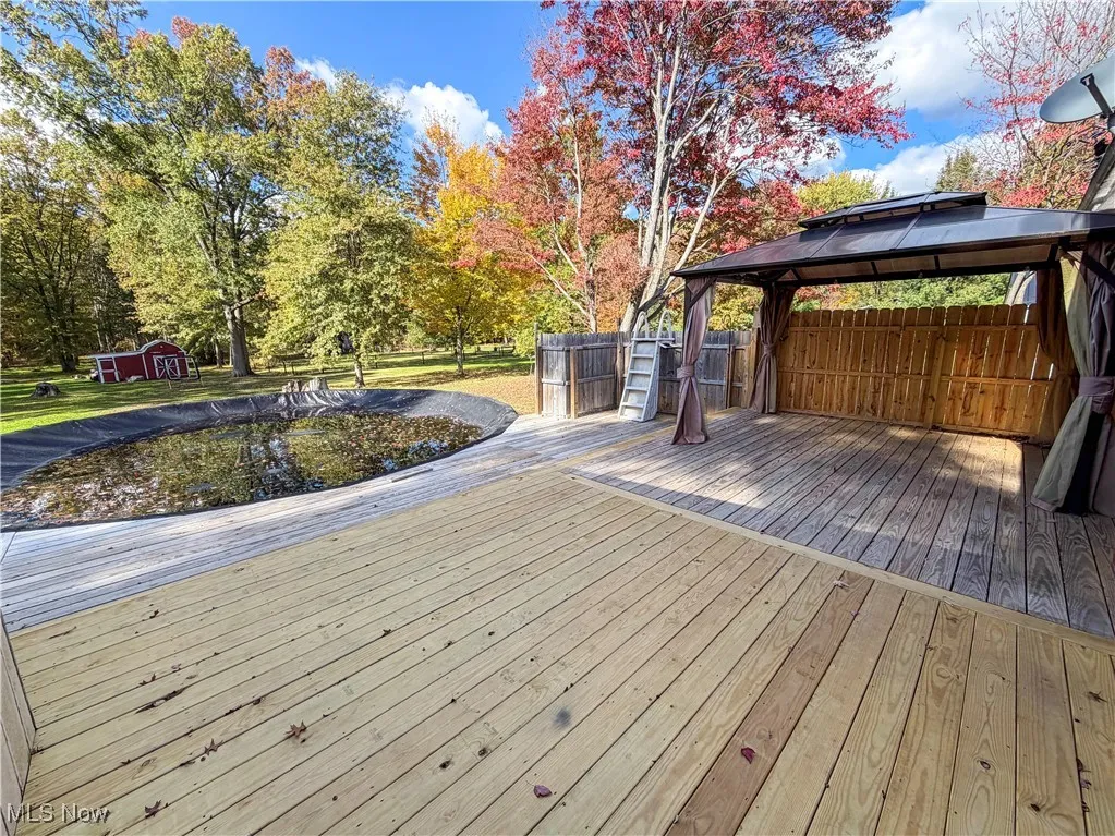 Wooden deck with a gazebo and a storage unit