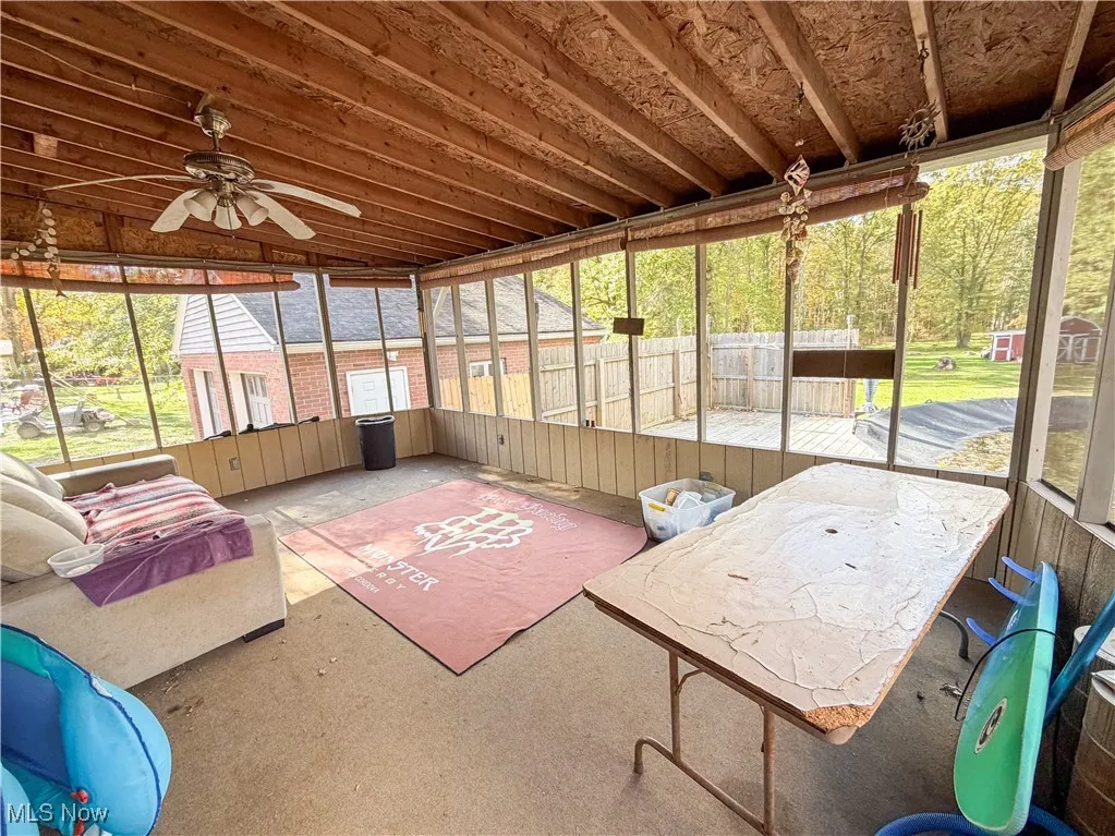 Sunroom with a ceiling fan