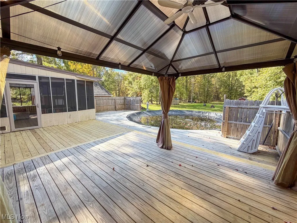 Deck featuring a sunroom