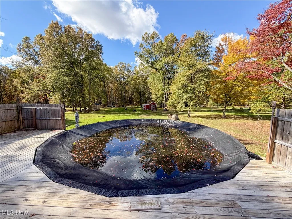 View of pool featuring a wooden deck