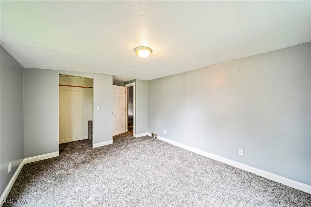 Unfurnished bedroom with carpet flooring, a closet, and a textured ceiling