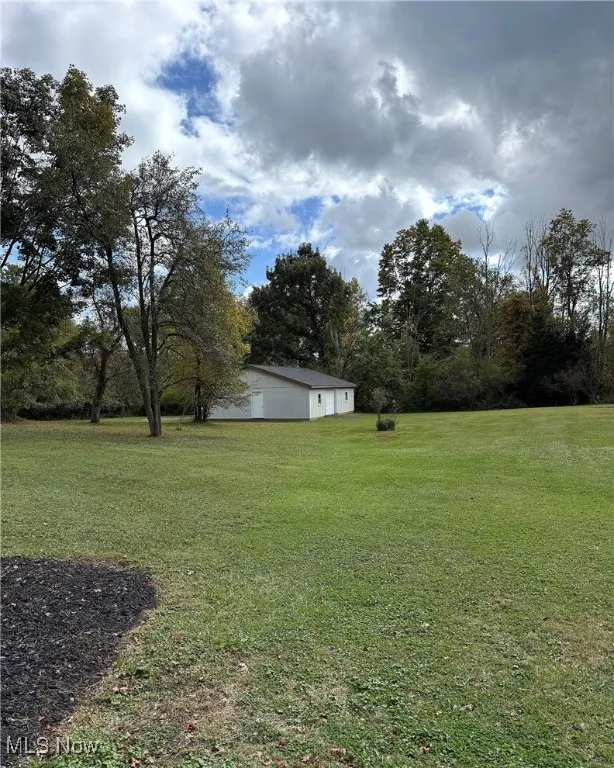 Spacious yard with a detached Barn or Garage, for additional space and parking.