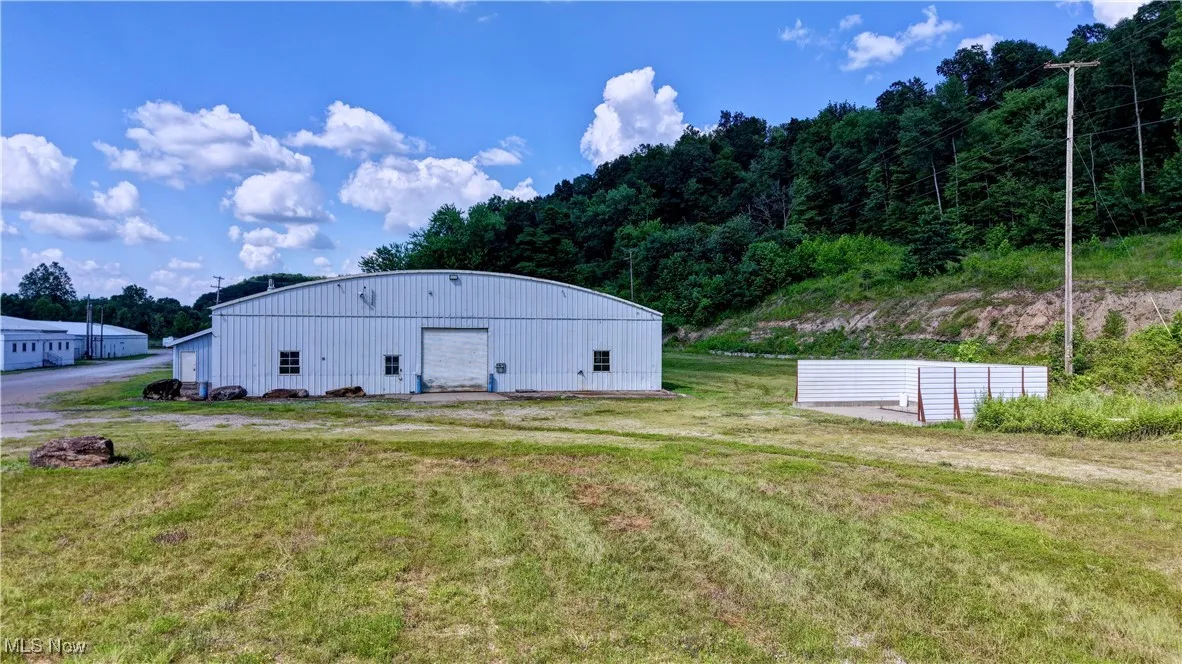 View of pole building featuring a yard