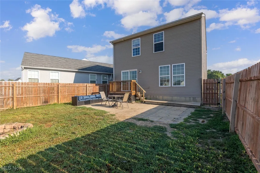 Back of property with a patio area, a fenced backyard