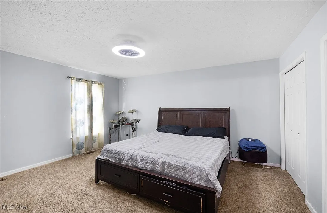 Bedroom featuring carpet floors and a textured ceiling
