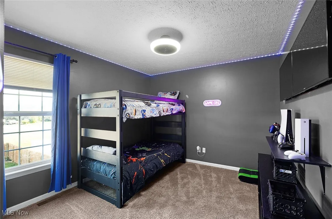 Carpeted bedroom featuring a textured ceiling