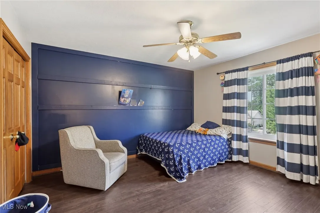 Bedroom with wood finished floors and a ceiling fan