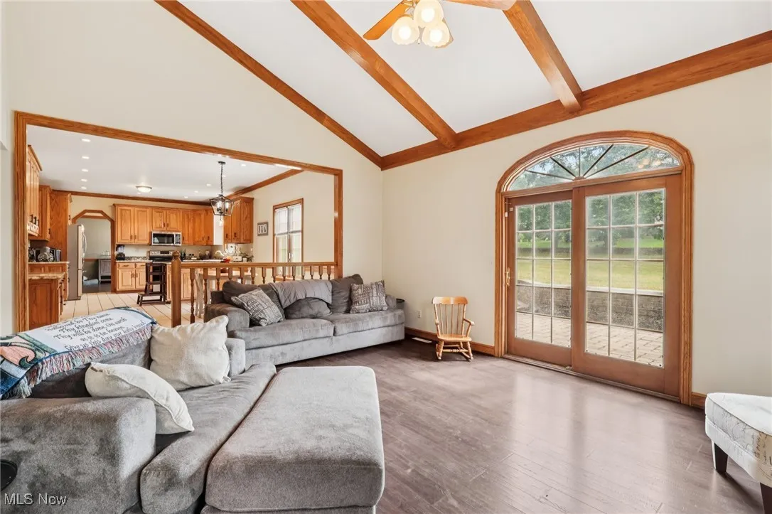 Living room featuring beamed ceiling, light wood-style floors, high vaulted ceiling, recessed lighting, and ceiling fan