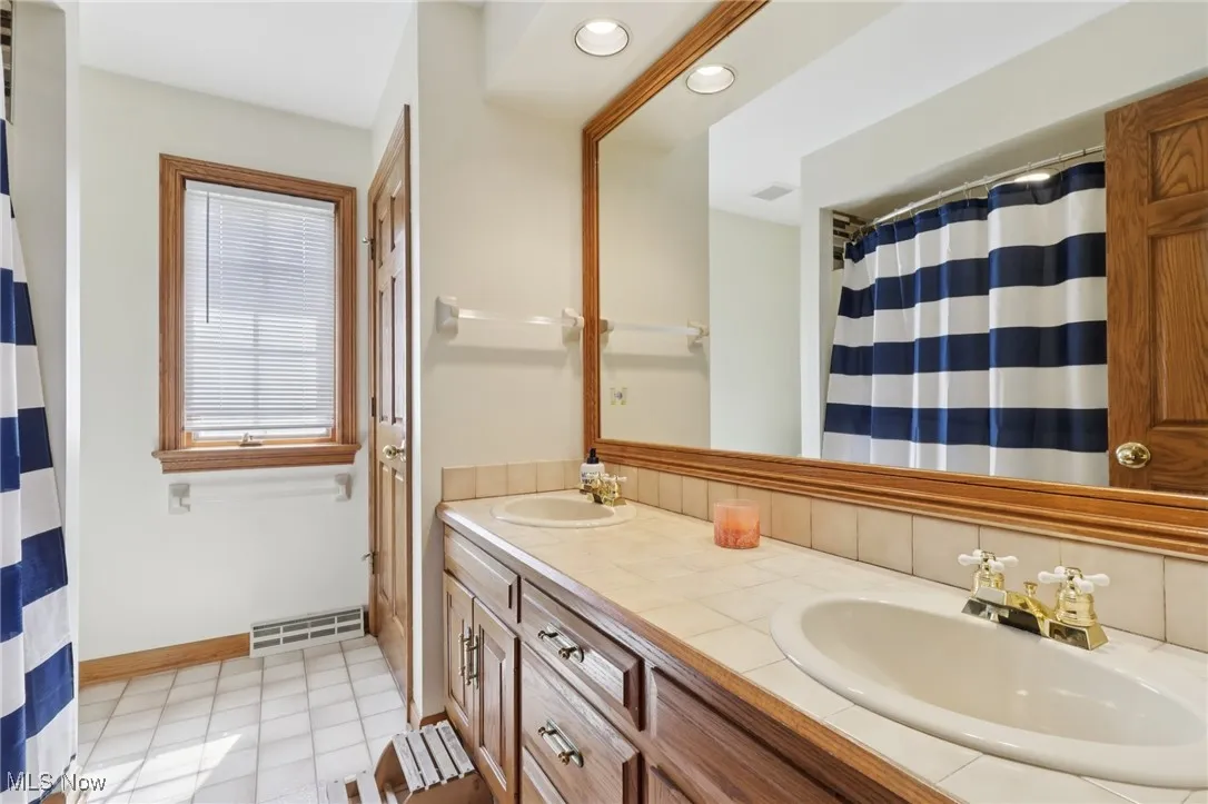 Full bath with double vanity and recessed lighting