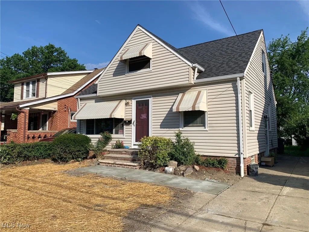 Bungalow-style house featuring roof with shingles